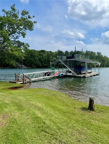 a view of wooden house with a large tree