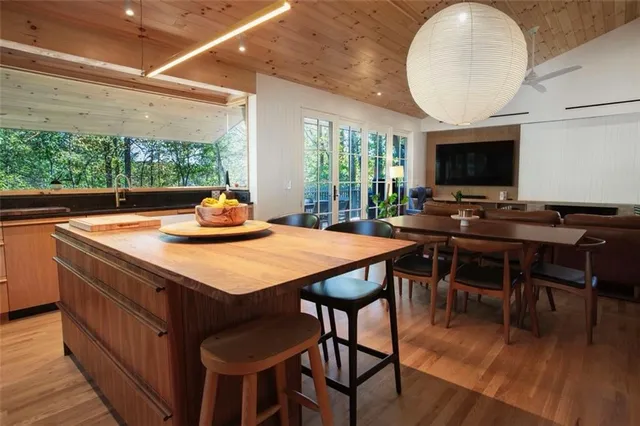 a kitchen with a appliances a counter space and a view of living room