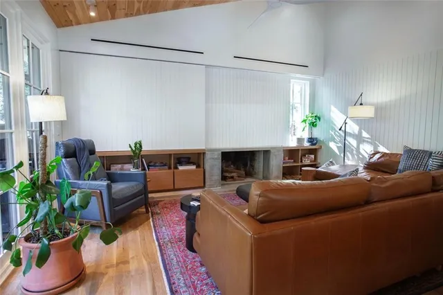 a living room with furniture potted plant and a large window