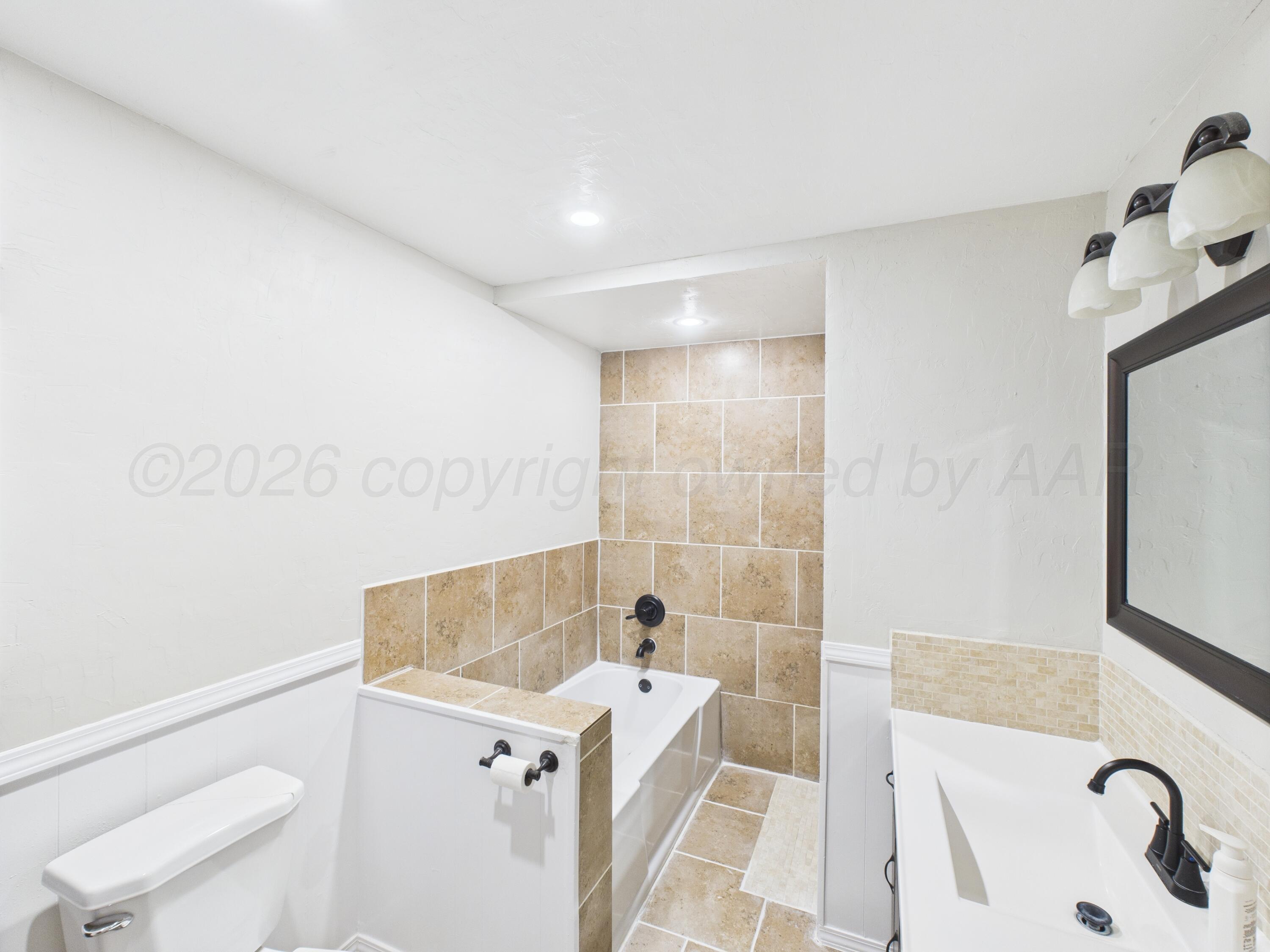 505 South Ridgeland Avenue Fritch, TX 79036 - Photo 12 of 19 a bathroom with a sink a toilet and shower