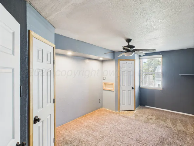 a view of a livingroom with a chandelier fan