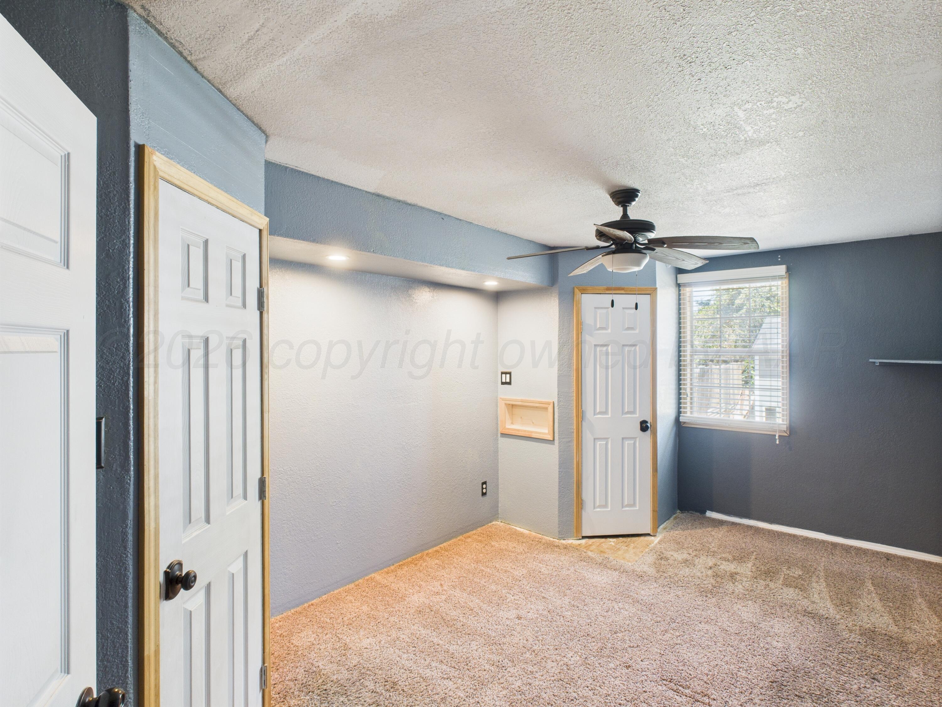 505 South Ridgeland Avenue Fritch, TX 79036 - Photo 14 of 19 a view of empty room with wooden floor and fan