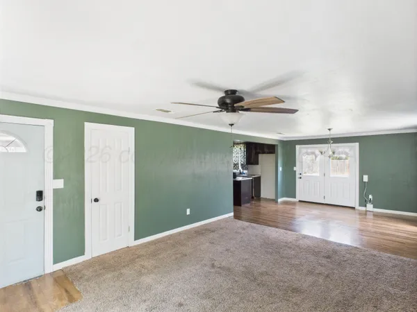 a view of a livingroom with a fireplace and window