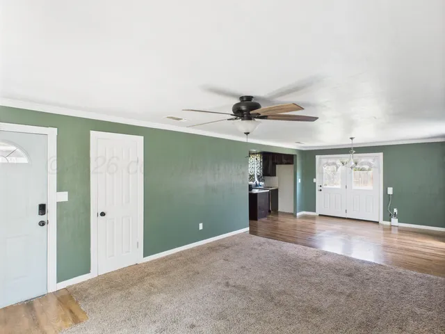 a view of a livingroom with a fireplace and window