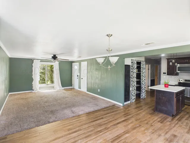 a living room with kitchen island furniture and a window