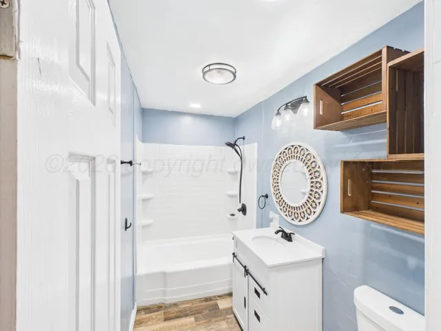 a bathroom with a sink a mirror and a shower