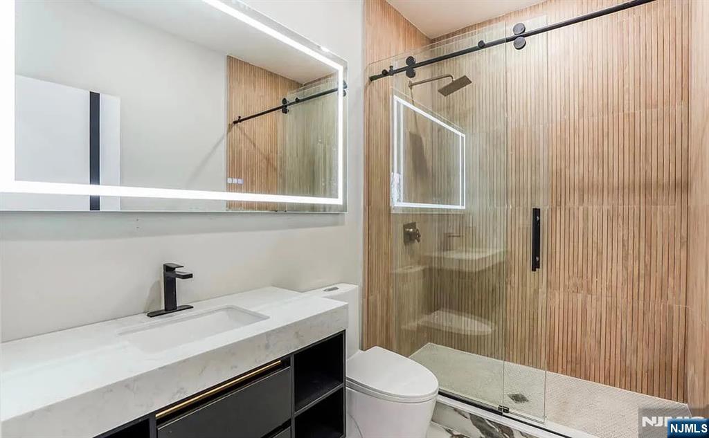 210 22nd Street, Unit 2 Irvington, NJ 07111 - Photo 11 of 20 a bathroom with a sink a toilet a shower and a window