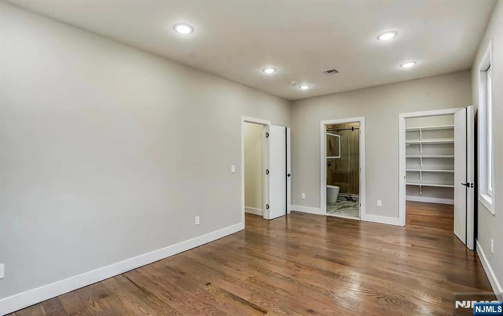 210 22nd Street, Unit 2 Irvington, NJ 07111 - Photo 17 of 20 a view of an empty room with a window and wooden floor
