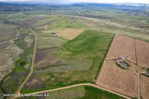 a view of a field with an ocean