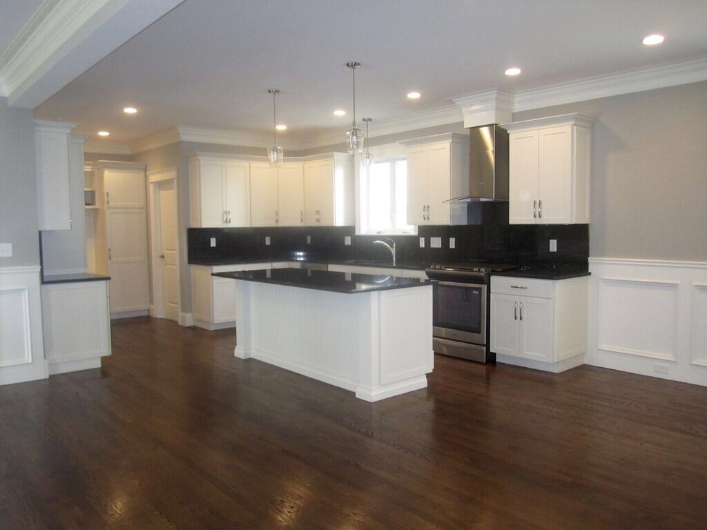 15 Margaret Road, Unit LEFT Newton, MA 02461 - Photo 1 of 8 a kitchen with stainless steel appliances kitchen island granite countertop a sink and cabinets