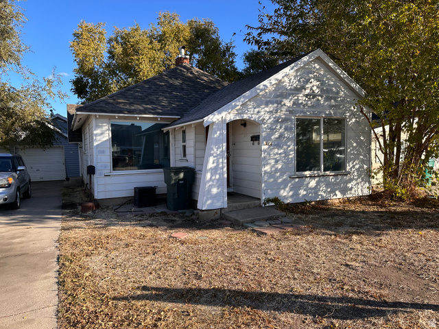 154 East Harris Street Ogden, UT 84401 - Photo 1 of 10 View of front facade with a shingled roof, a chimney, an outdoor structure, and a garage