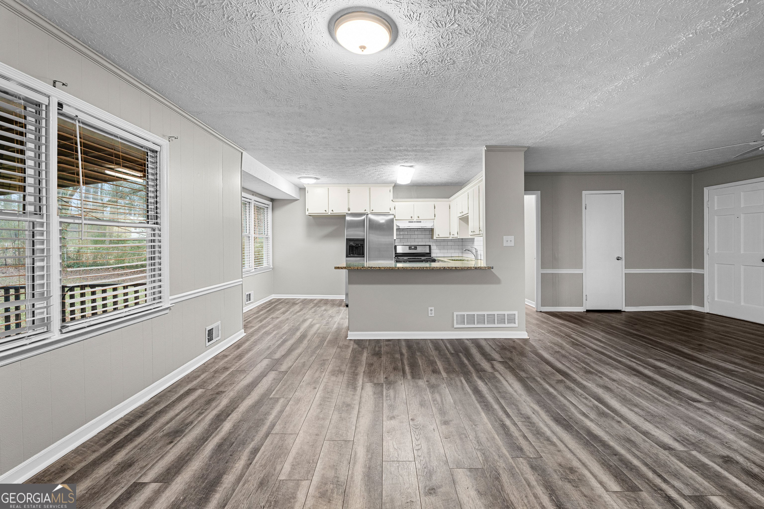 96 Poplar Road Newnan, GA 30263 - Photo 12 of 33 a view of empty room with wooden floor and windows