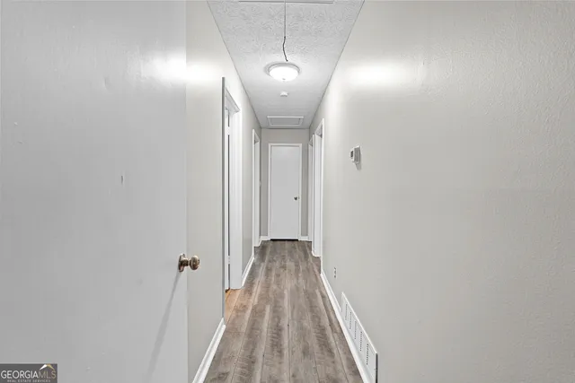 a view of a room with wooden floor and staircase