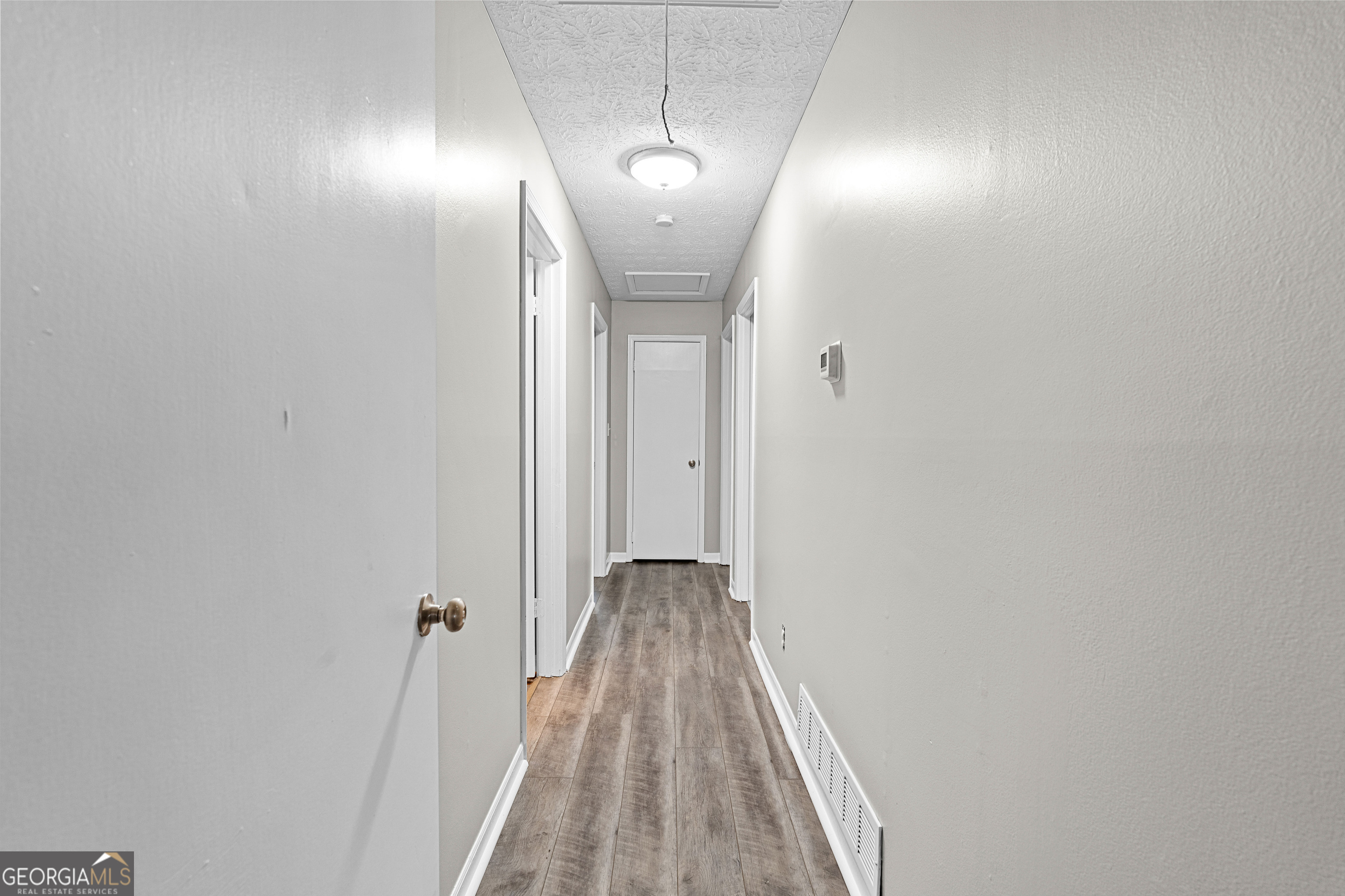 96 Poplar Road Newnan, GA 30263 - Photo 17 of 33 a view of a room with wooden floor and staircase