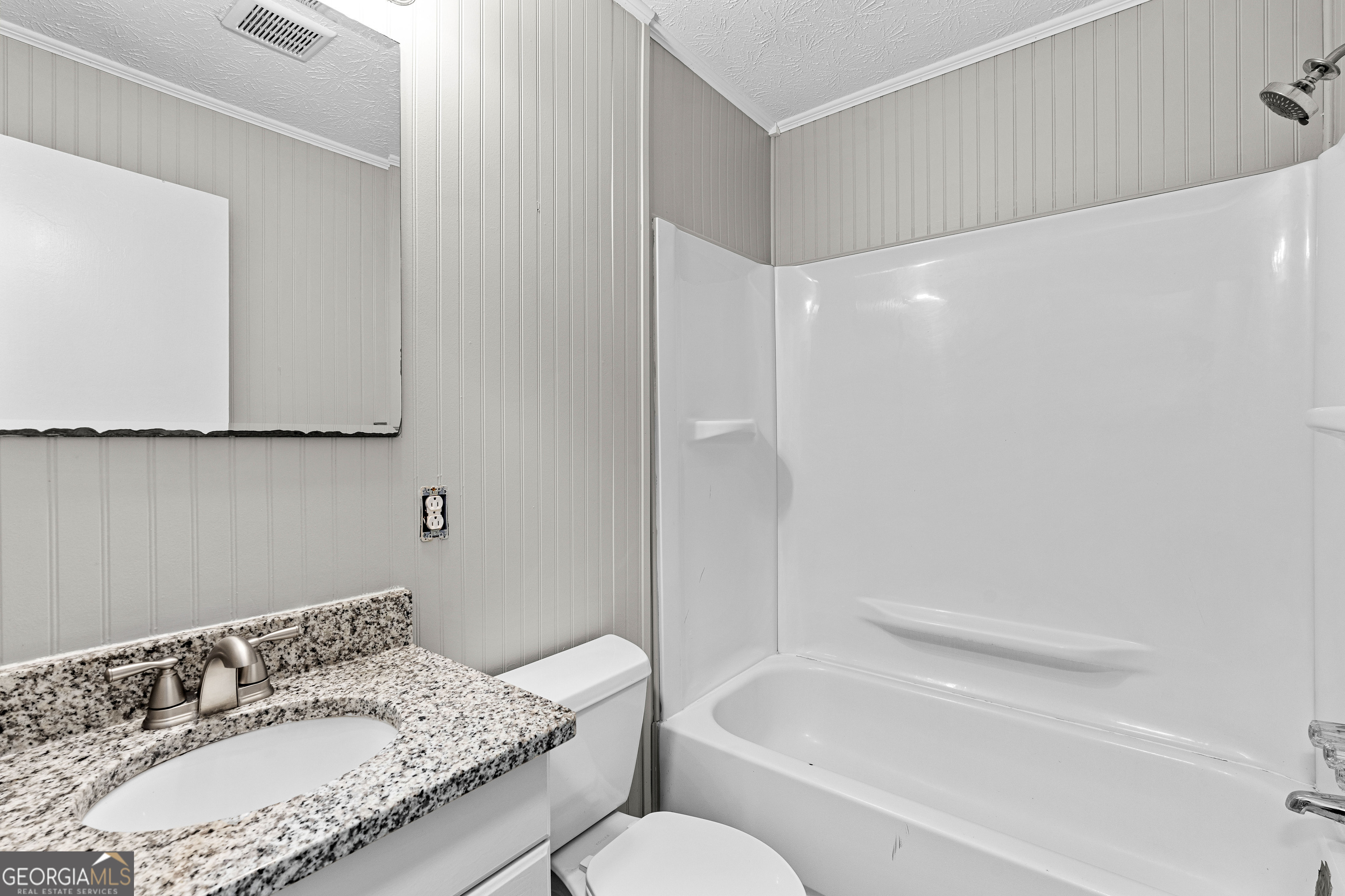 96 Poplar Road Newnan, GA 30263 - Photo 18 of 33 a bathroom with a granite countertop sink and a mirror