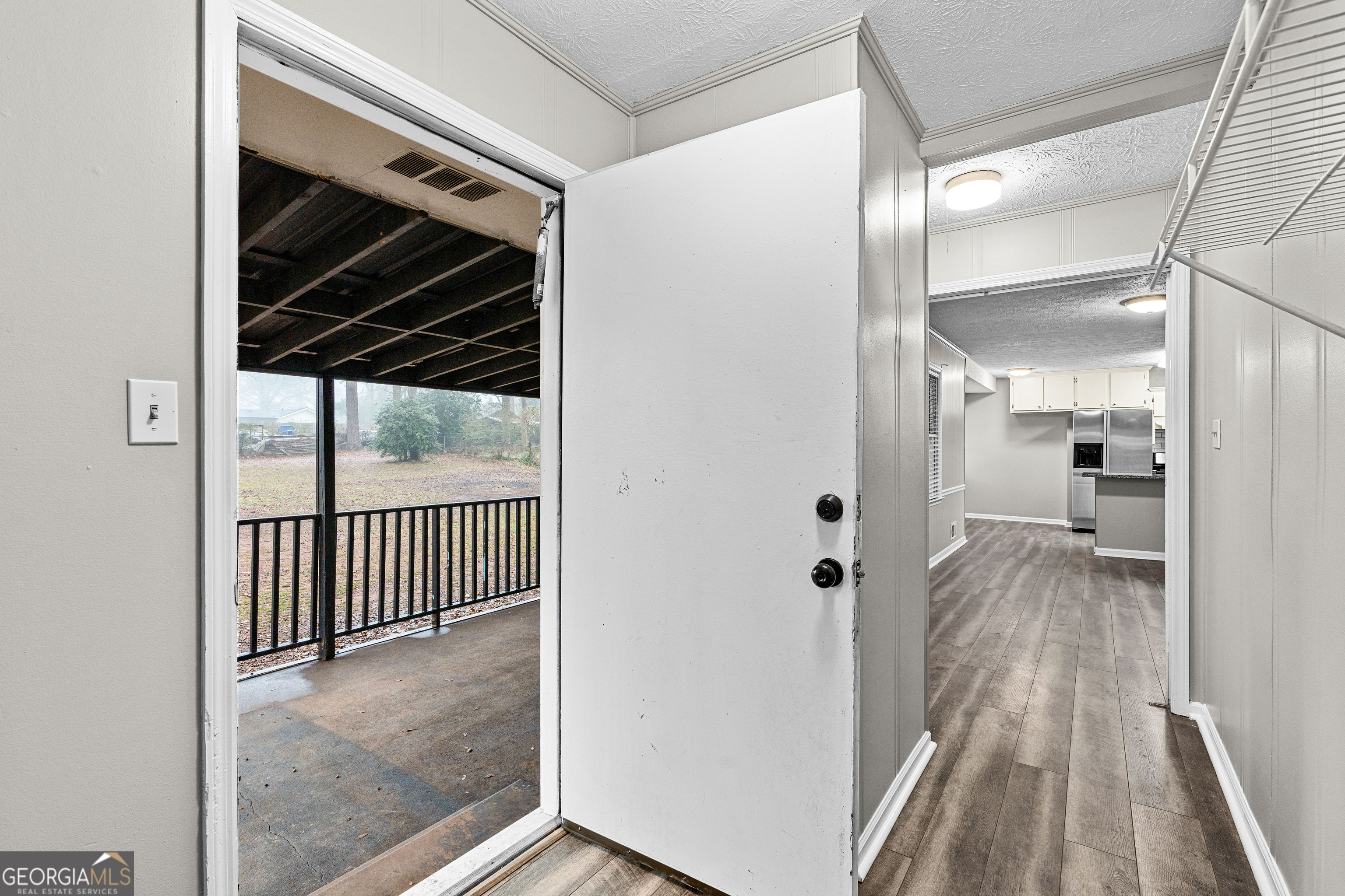 96 Poplar Road Newnan, GA 30263 - Photo 27 of 33 a view of a hallway with wooden floor and staircase