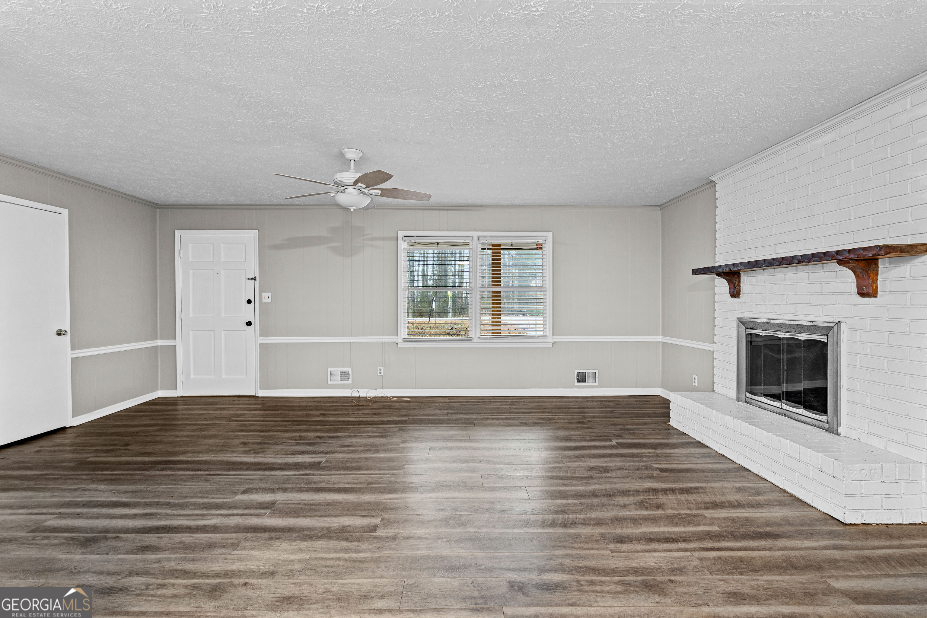 96 Poplar Road Newnan, GA 30263 - Photo 8 of 33 a view of an empty room with window and fire place