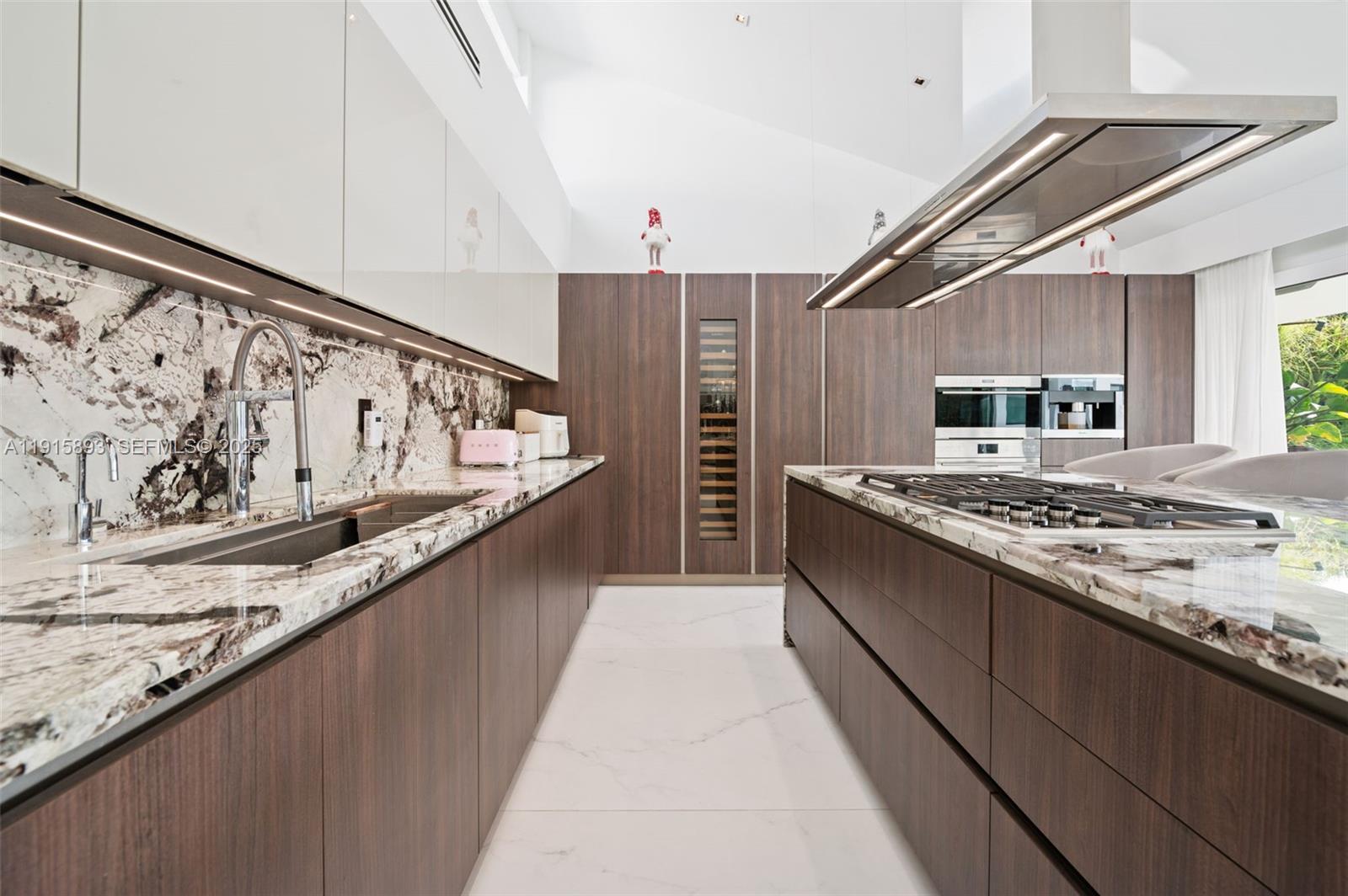 1792 Cleveland Road Miami Beach, FL 33141 - Photo 12 of 39 a large kitchen with stainless steel appliances granite countertop a stove and a sink