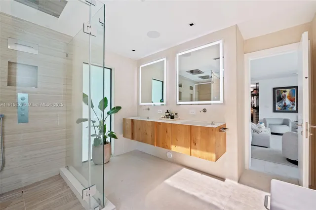 a bathroom with a toilet a sink a mirror and a shower