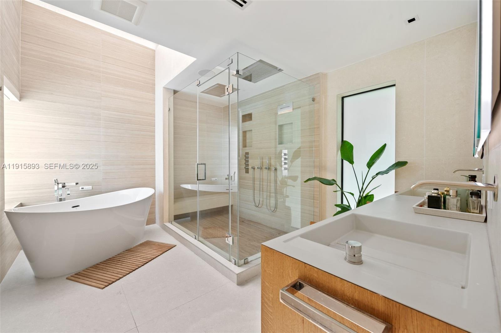 1792 Cleveland Road Miami Beach, FL 33141 - Photo 17 of 39 a bathroom with a tub sink and mirror
