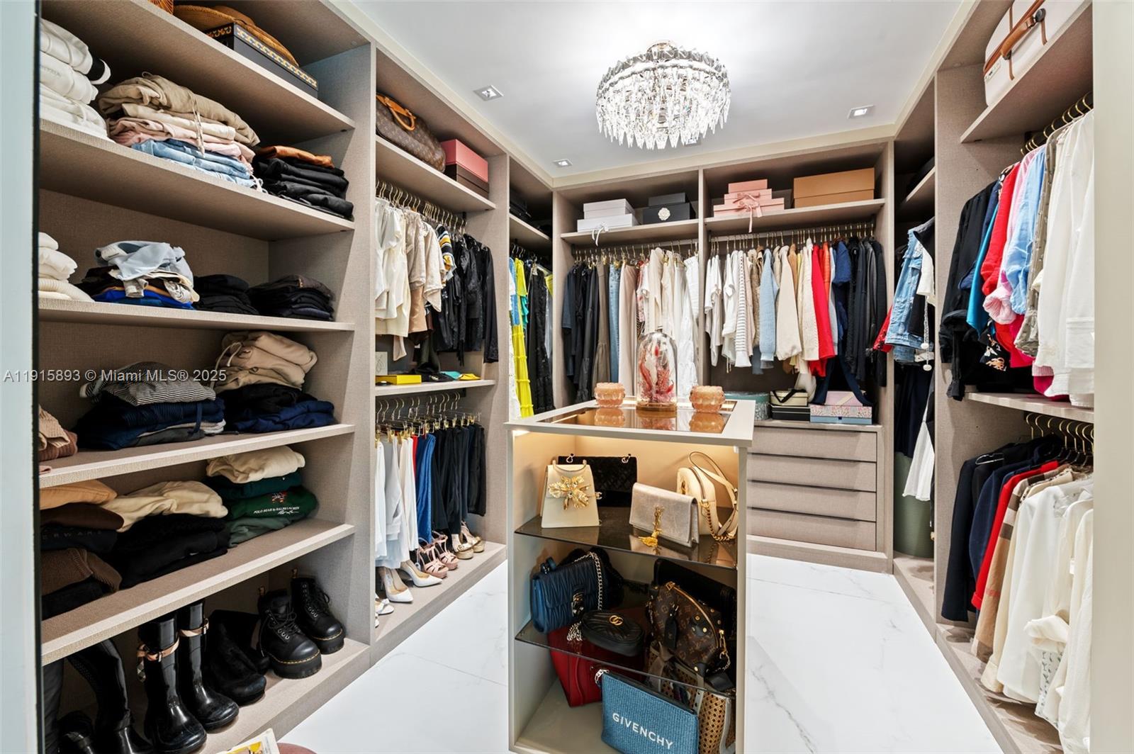 1792 Cleveland Road Miami Beach, FL 33141 - Photo 18 of 39 a view of walk in closet with clothes and shoes
