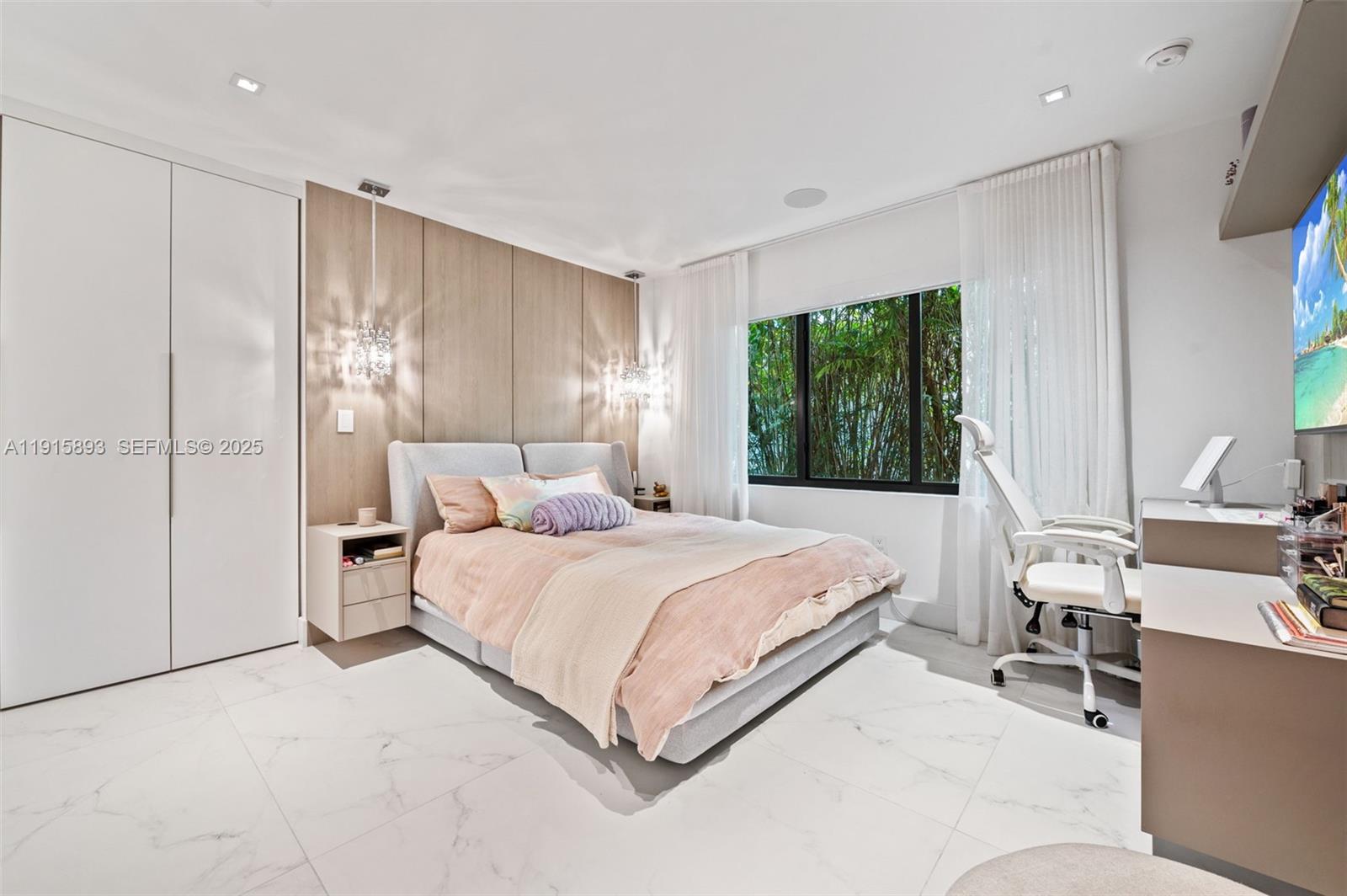 1792 Cleveland Road Miami Beach, FL 33141 - Photo 19 of 39 a bedroom with a large bed and a window