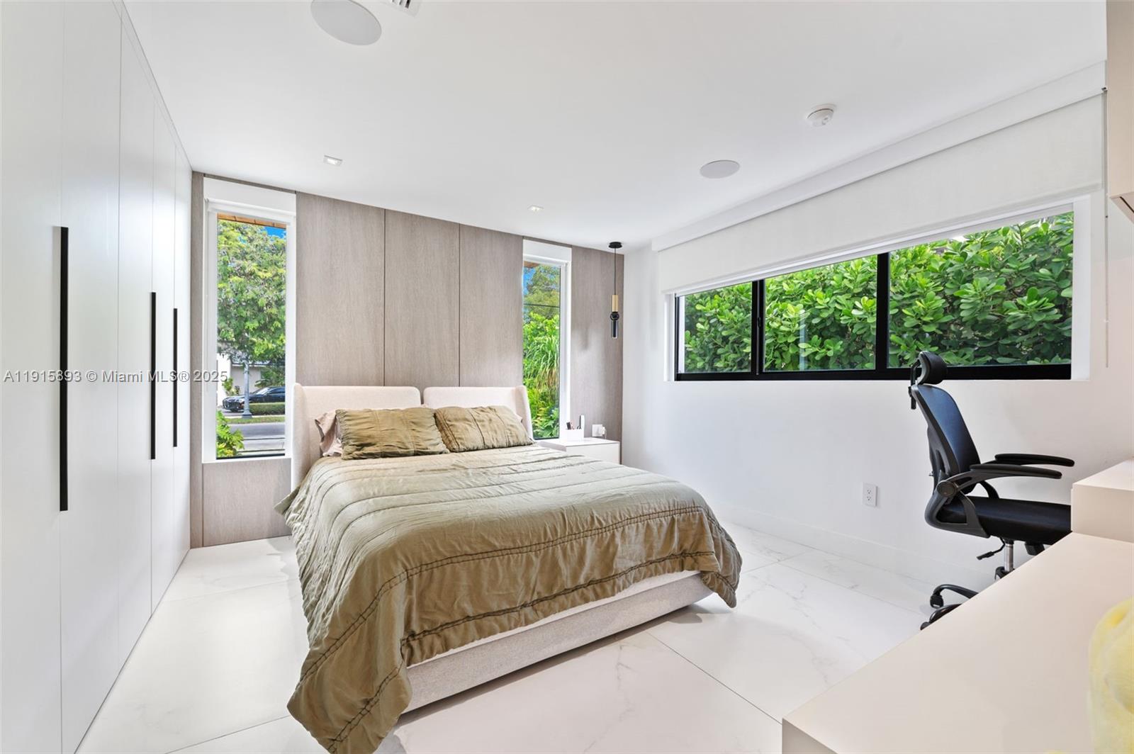 1792 Cleveland Road Miami Beach, FL 33141 - Photo 21 of 39 a bedroom with a bed and large window