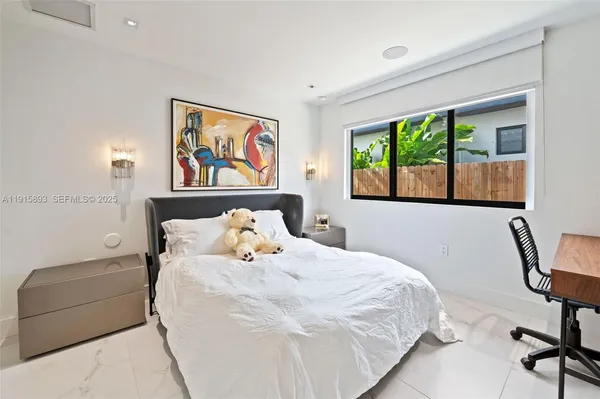 a bedroom with a bed a couch and a window