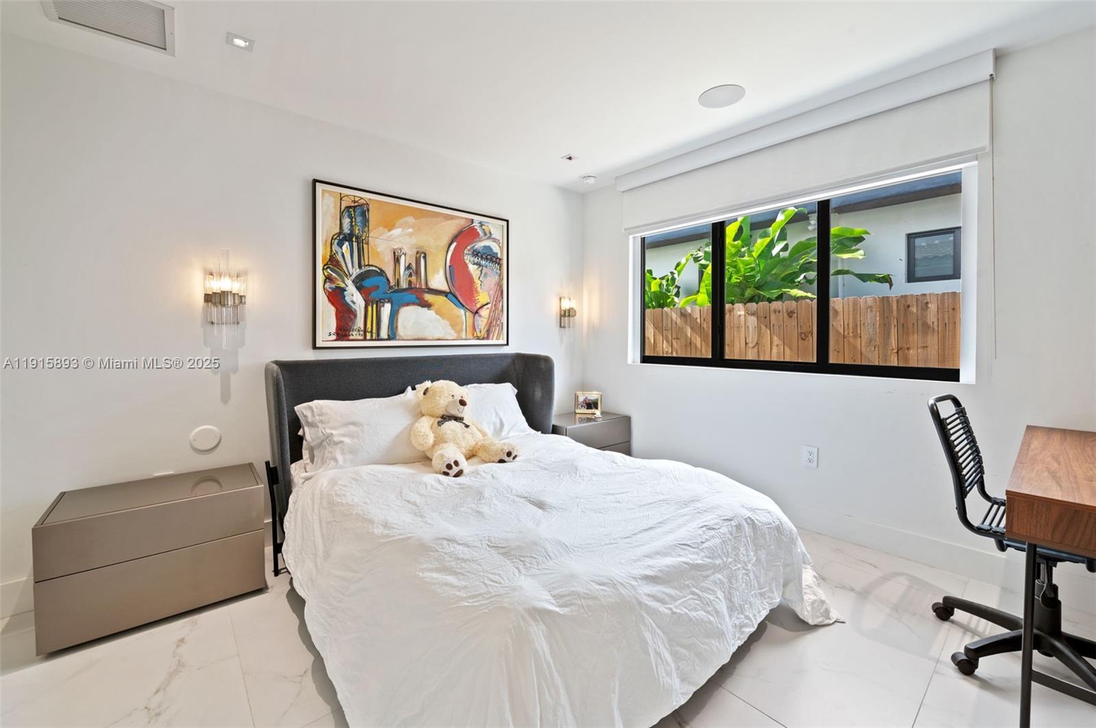 1792 Cleveland Road Miami Beach, FL 33141 - Photo 23 of 39 a bedroom with a bed a couch and a window