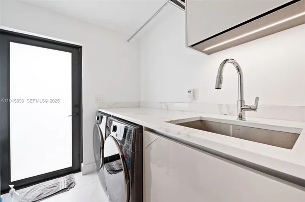 a utility room with two sink and a washer