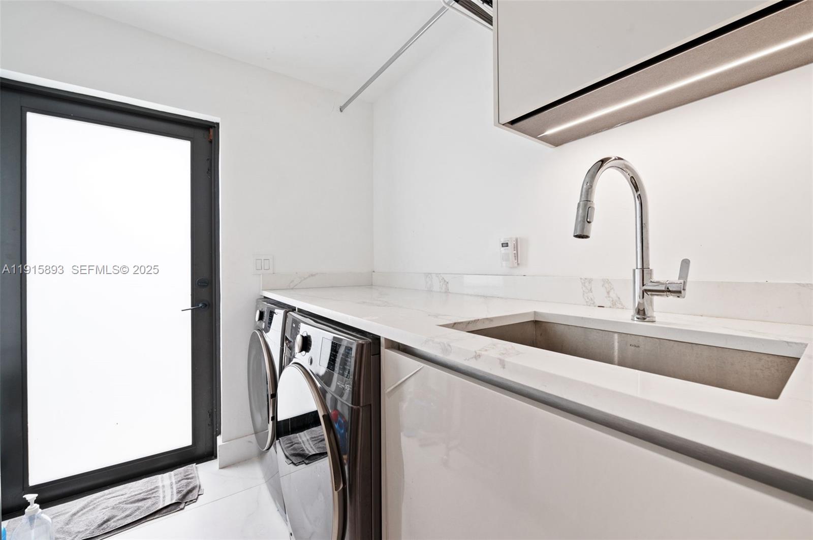 1792 Cleveland Road Miami Beach, FL 33141 - Photo 25 of 39 a utility room with two sink and a washer