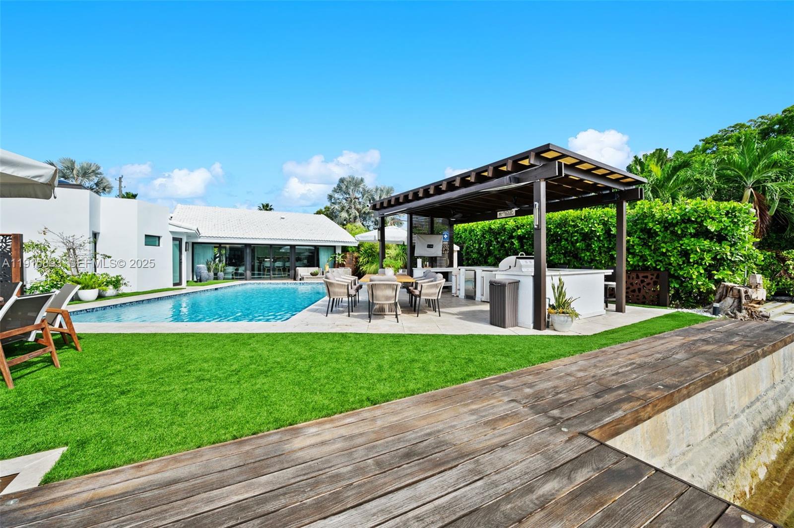 1792 Cleveland Road Miami Beach, FL 33141 - Photo 31 of 39 a view of a patio with a table and chairs under an umbrella