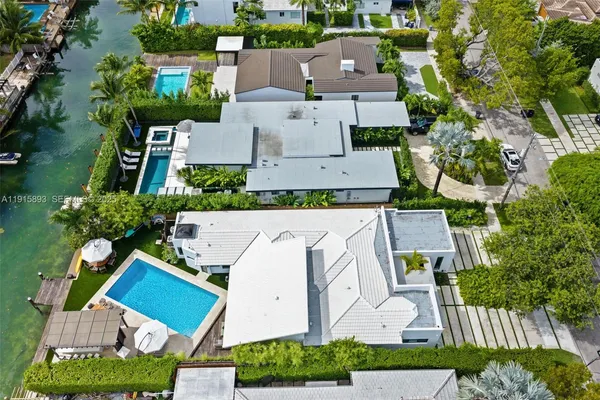 an aerial view of multiple houses with a yard