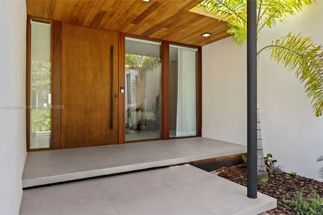 a kitchen with stainless steel appliances kitchen island granite countertop a table chairs microwave and sink