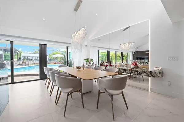 a dining room with furniture and a large window