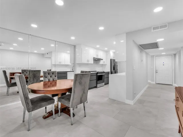 a dining area with a table and chairs in it