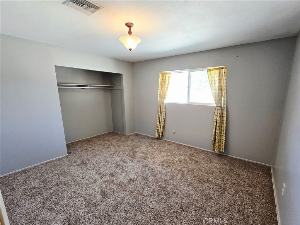 20221 Modoc Road Apple Valley, CA 92308 - Photo 14 of 23 an empty room with a window