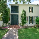 a view of a house with a yard and plants
