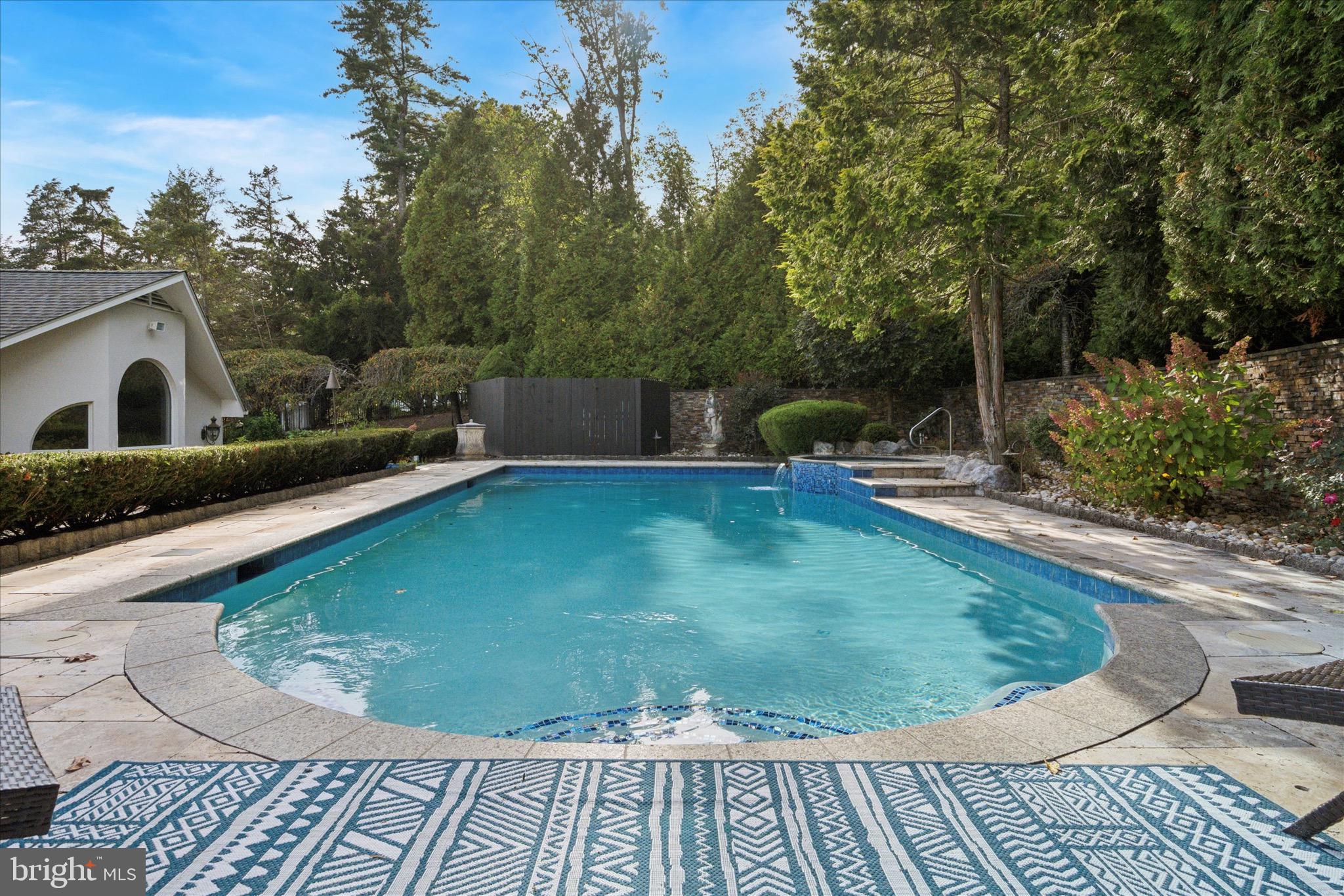 1087 Mt Eyre Road Washington Crossing, PA 18977 - Photo 25 of 77 a view of a swimming pool with a sitting space