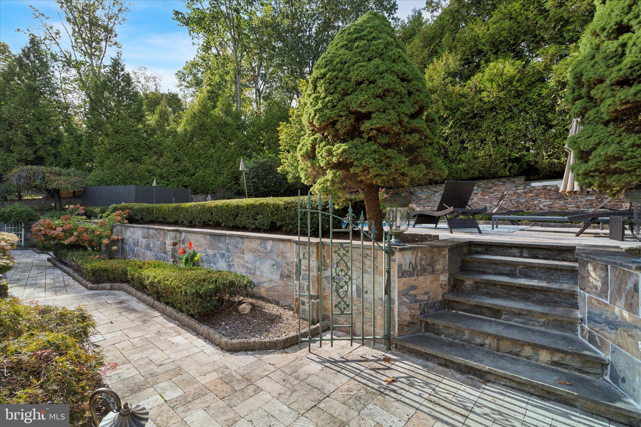 1087 Mt Eyre Road Washington Crossing, PA 18977 - Photo 27 of 77 a view of a backyard with plants and a patio