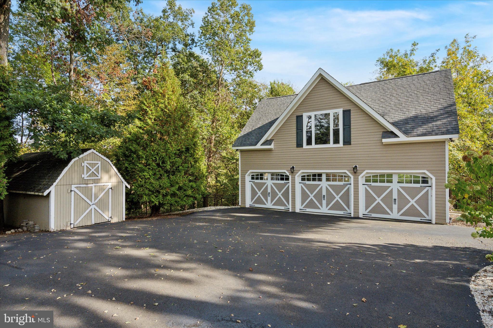 1087 Mt Eyre Road Washington Crossing, PA 18977 - Photo 67 of 77 a front view of a house with a yard and garage