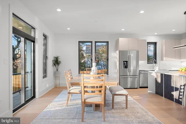 a living room with furniture a window and a potted plant