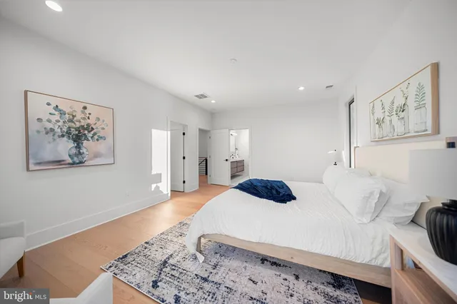 a bedroom with a large bed and a couch