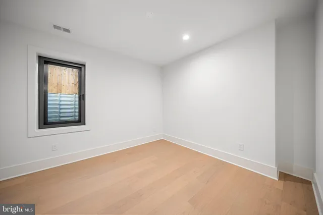 a view of an empty room with a kitchen
