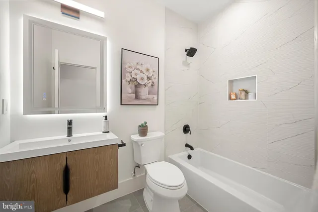 a bathroom with a sink a toilet and a bathtub