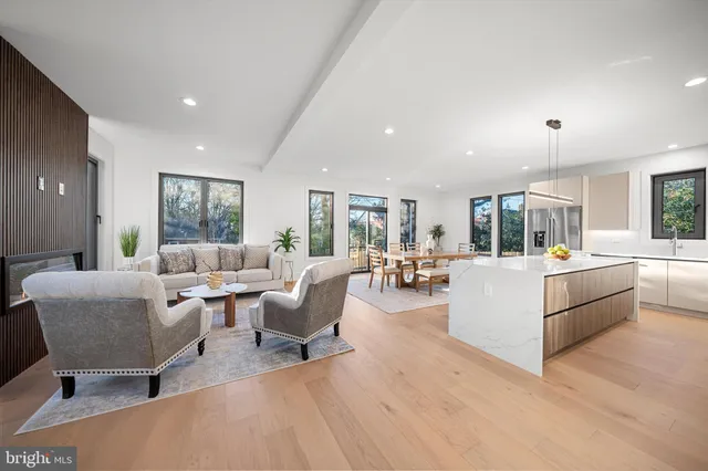 a front view of a house with a yard and trees