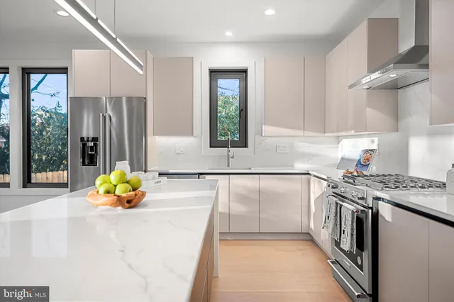 a kitchen with a refrigerator and a stove top oven