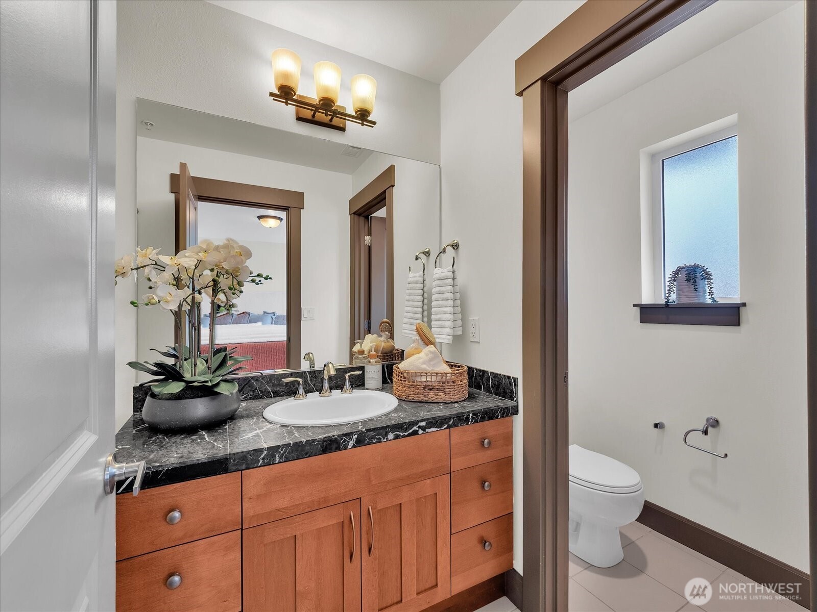 2115 201st Place Southeast, Unit K2 Bothell, WA 98012 - Photo 16 of 28 a bathroom with a granite countertop sink a toilet and a mirror
