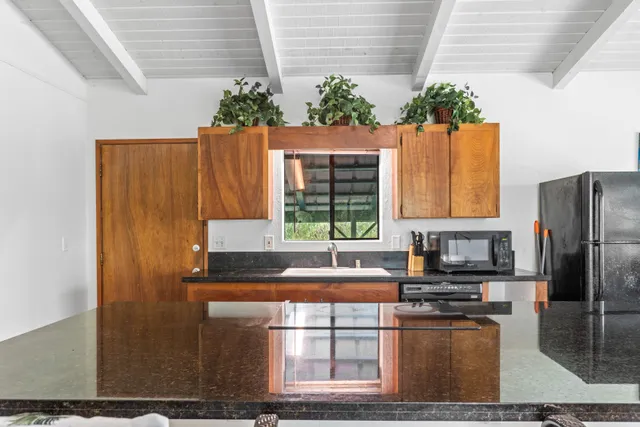 a kitchen with sink and refrigerator