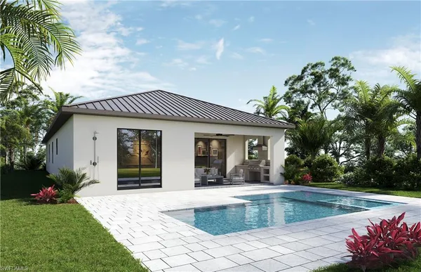 a view of a house with pool fire pit next to a yard